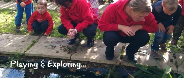 Playing & Exploring slider image Image of children and staff exploring by pond